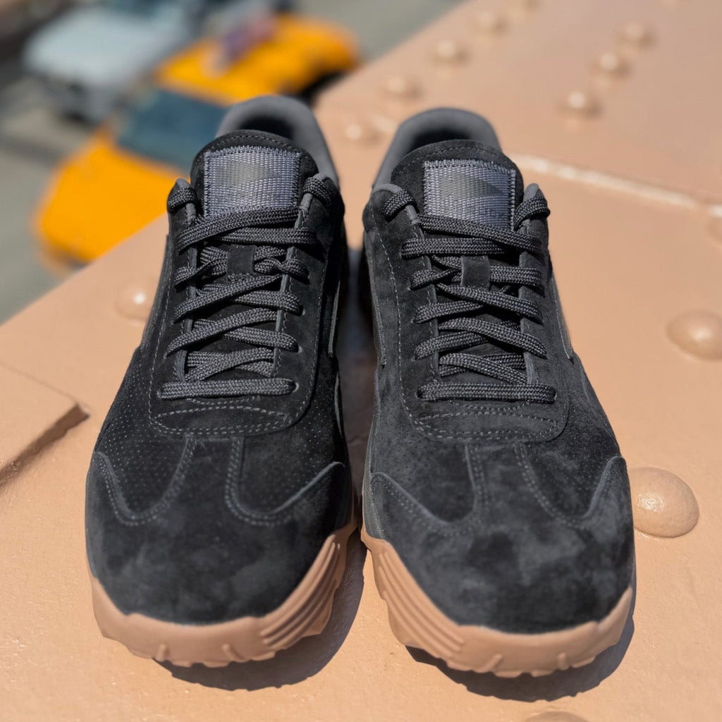 Pair of black suede Mackall 45 shoes with gum soles on a neutral surface