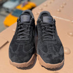 Pair of black suede Mackall 45 shoes with gum soles on a neutral surface